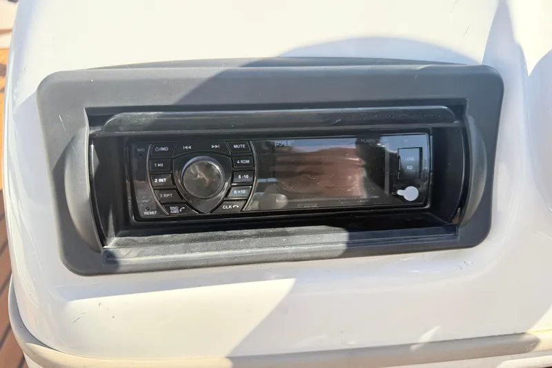 Slide: The Image of Stereo system on a 2011 Sun Tracker Fishin' Barge 21 boat dashboard. - 14