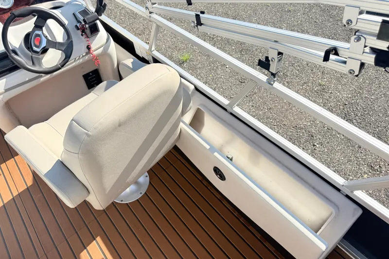 Slide: The Image of 2011 Sun Tracker Fishin' Barge 21 interior with steering wheel and seating. - 15