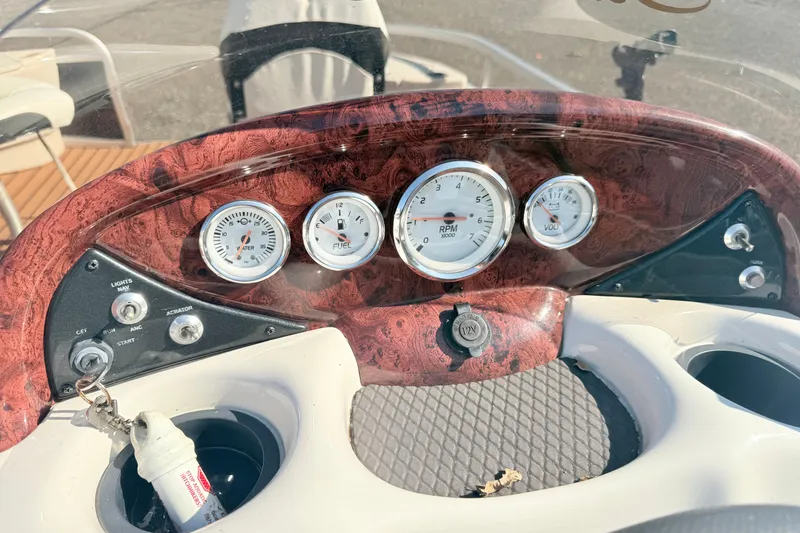 Slide: The Image of Dashboard of a 2011 Sun Tracker Fishin' Barge 21 with gauges and controls. - 13