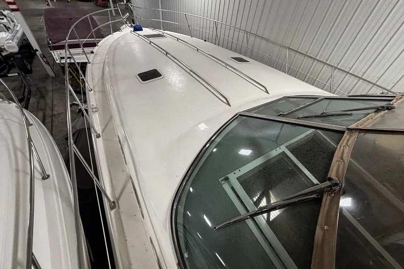 Slide: The Image of 1994 Sea Ray 400 Express Cruiser in storage, showcasing sleek design and spacious deck. - 3