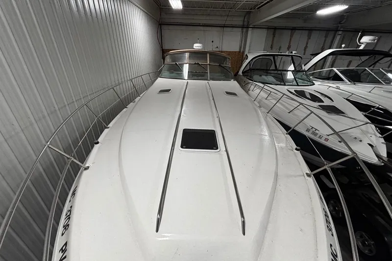 Slide: The Image of 1994 Sea Ray 400 Express Cruiser in storage, showcasing sleek design and spacious deck. - 4