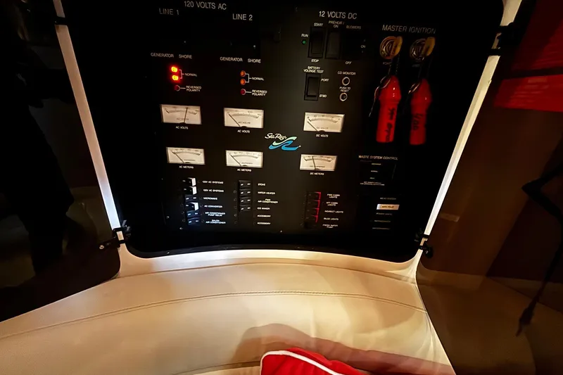 Slide: The Image of Control panel of a 1994 Sea Ray 400 Express Cruiser with gauges and switches. - 12