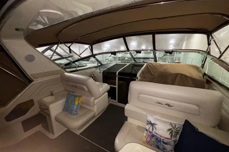 Slide: The Image of 1994 Sea Ray 400 Express Cruiser interior with seating and helm, featuring nautical decor. - 29
