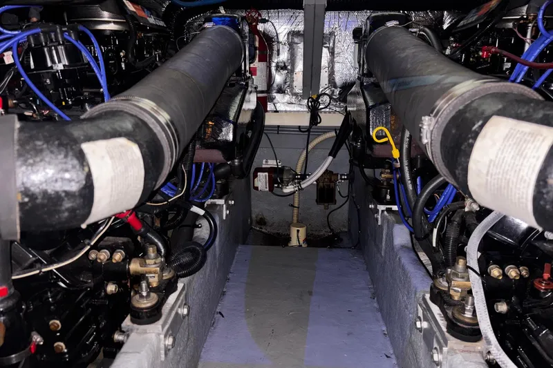 Slide: The Image of Engine room of a 1994 Sea Ray 400 Express Cruiser with visible components and wiring. - 23