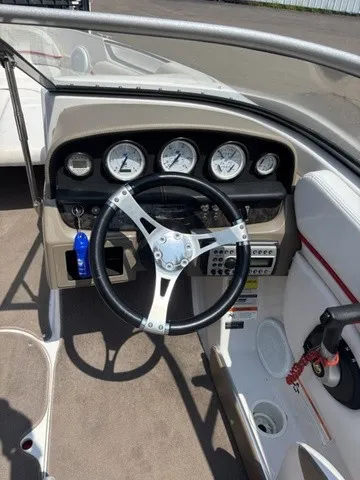 Slide: The Image of The image shows the cockpit of a 2007 Four Winns 200 Horizon with a modern steering wheel and gauges. - 13