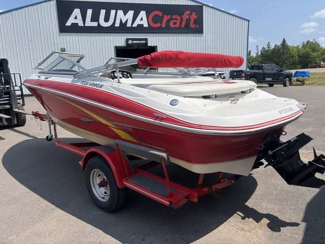 Slide: The Image of A red 2007 Four Winns 200 Horizon boat on a trailer in front of an Alumacraft building. - 6