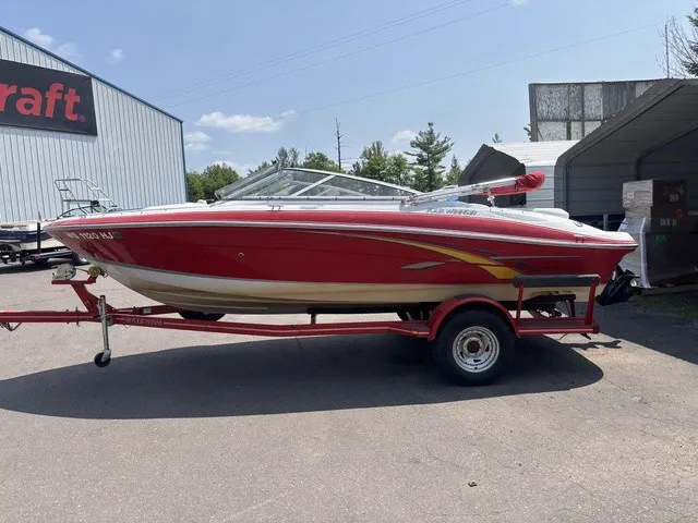 Slide: The Image of A red 2007 Four Winns 200 Horizon boat on a trailer, parked outdoors. - 5