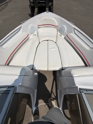 Slide: The Image of The image shows the bow of a 2007 Four Winns 200 Horizon boat with white upholstery. - 9