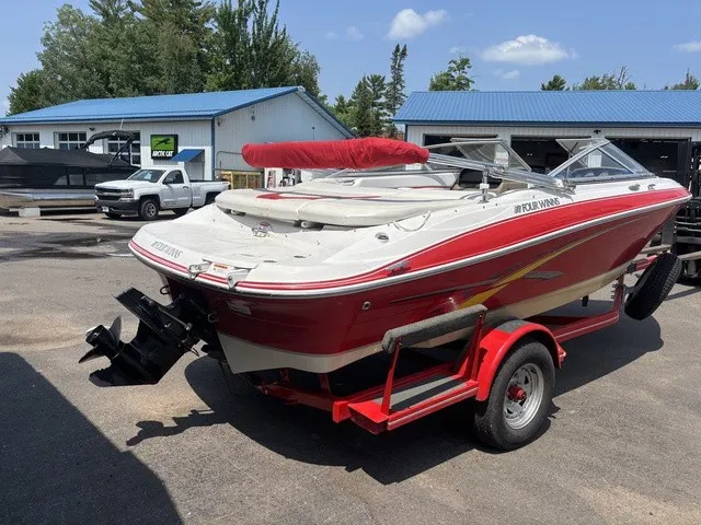 Slide: The Image of 2007 Four Winns 200 Horizon boat on a red trailer, parked outdoors. - 8
