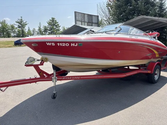 Slide: The Image of A red 2007 Four Winns 200 Horizon boat on a trailer, parked in a lot. - 4