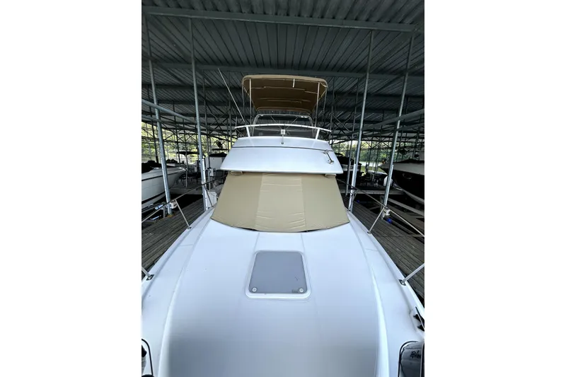 Slide: The Image of 1999 Carver 326 Aft Cabin Motor Yacht docked under shelter. - 4