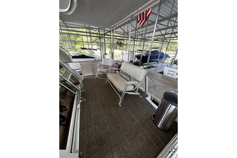 Slide: The Image of 1999 Carver 326 Aft Cabin Motor Yacht interior with seating and dock view. - 9