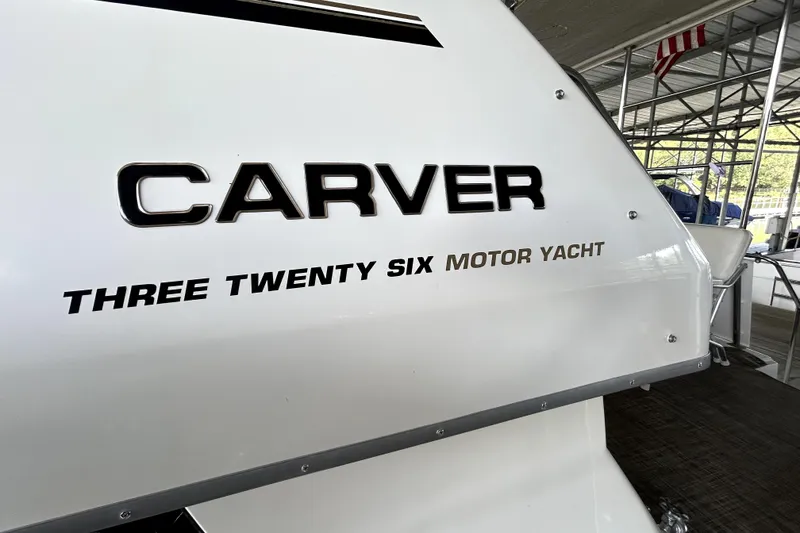 Slide: The Image of 1999 Carver 326 Aft Cabin Motor Yacht, docked with visible branding. - 6