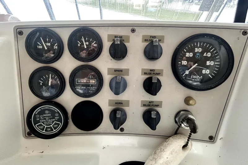 Slide: The Image of Control panel of a 1999 Carver 326 Aft Cabin Motor Yacht with gauges and switches. - 16