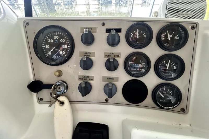 Slide: The Image of Control panel of a 1999 Carver 326 Aft Cabin Motor Yacht with gauges and switches. - 15