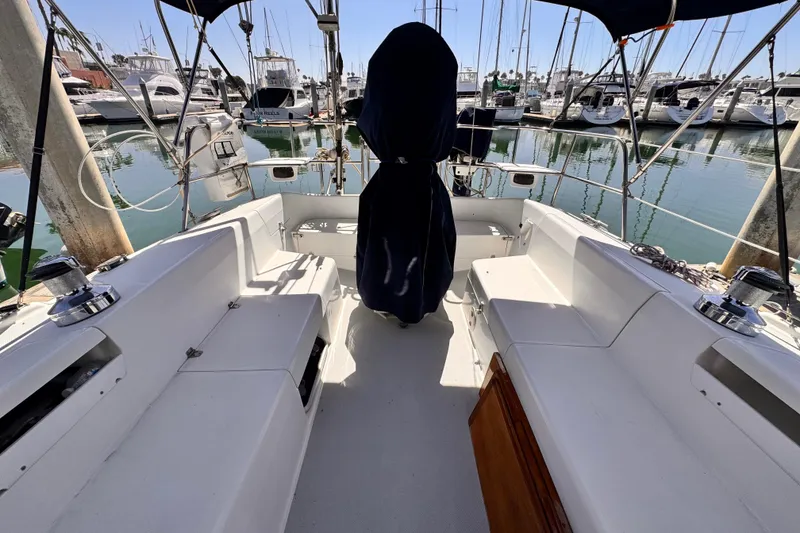 Slide: The Image of 2006 Catalina 34 MkII sailboat cockpit with marina view, featuring seating and covered helm. - 14