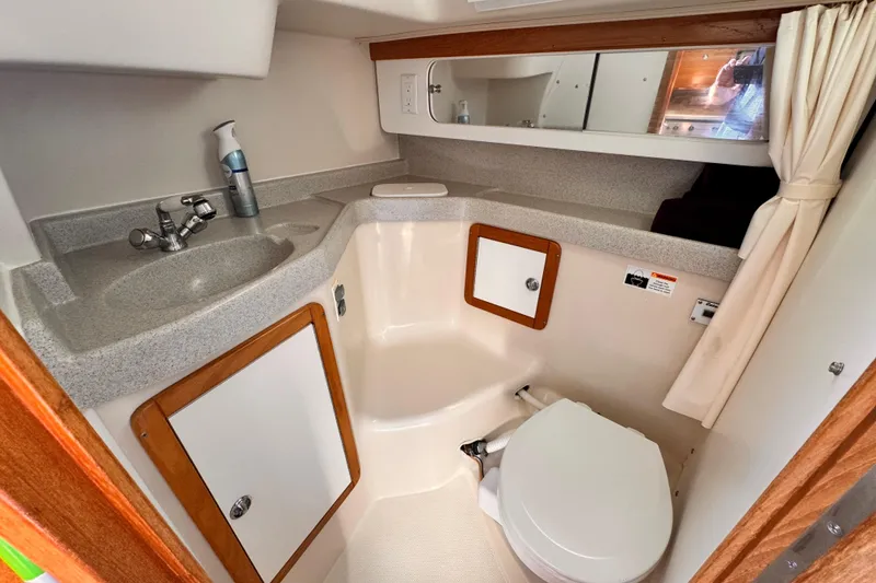 Slide: The Image of 2006 Catalina 34 MkII yacht bathroom with sink, toilet, and storage cabinets. - 7