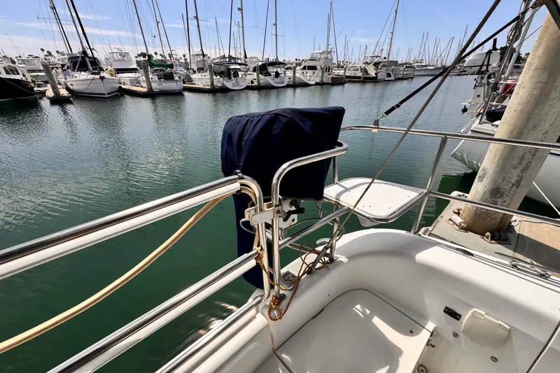 Slide: The Image of 2006 Catalina 34 MkII sailboat docked in a marina, surrounded by other boats. - 5