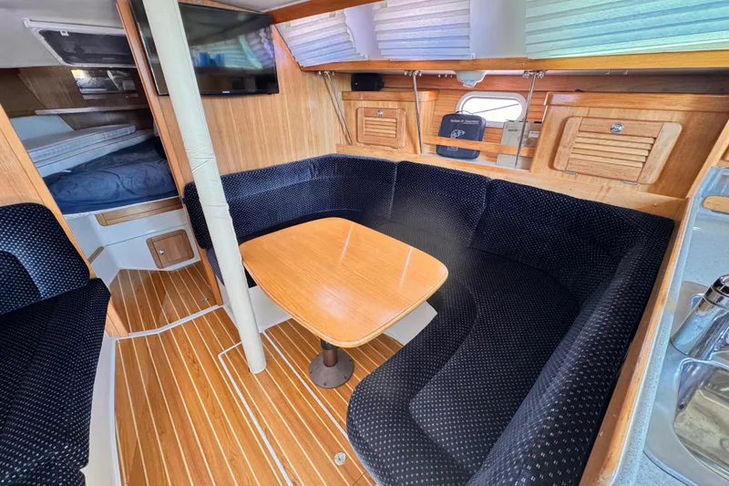 Slide: The Image of Interior of 2006 Catalina 34 MkII sailboat with cozy seating and wooden table. - 4