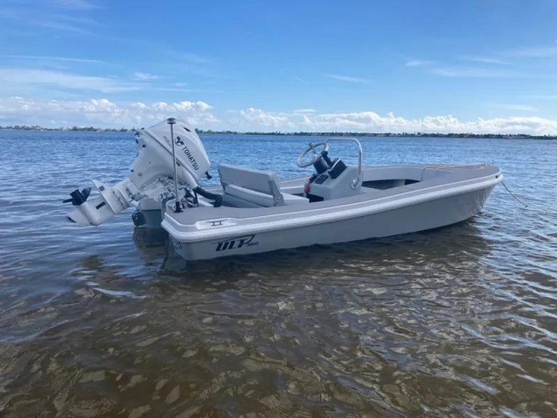 The Image of 2024 Ultra Lite Tenders ULT 380 boat on calm water under blue sky. - 1