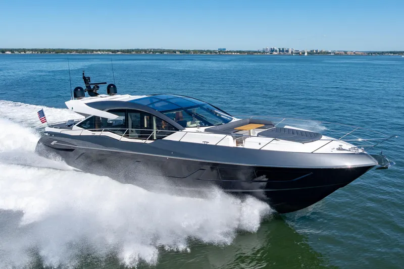 Slide: The Image of 2020 Sunseeker Predator 74 yacht cruising on open water, showcasing sleek design and luxury. - 1