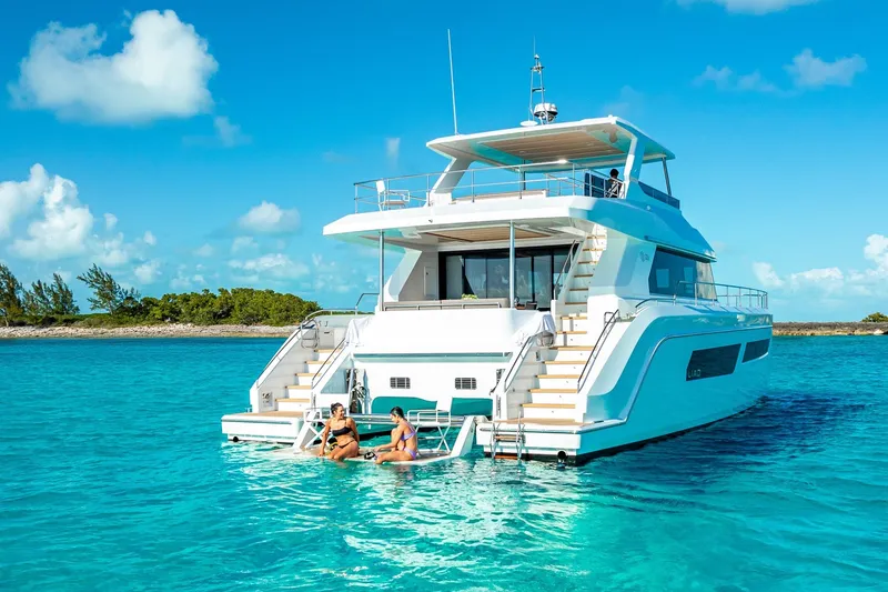 Slide: The Image of Luxurious ILIAD 53F yacht in turquoise waters, 2027 model, with people relaxing on the deck. - 2