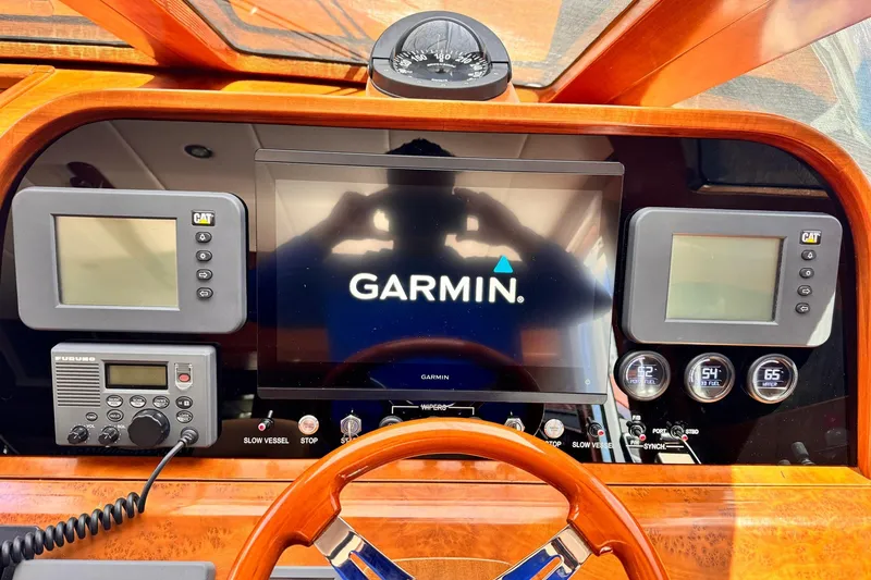 Slide: The Image of Dashboard of 2009 Grand Harbour 66 Motoryacht featuring Garmin navigation system and control instruments. - 42