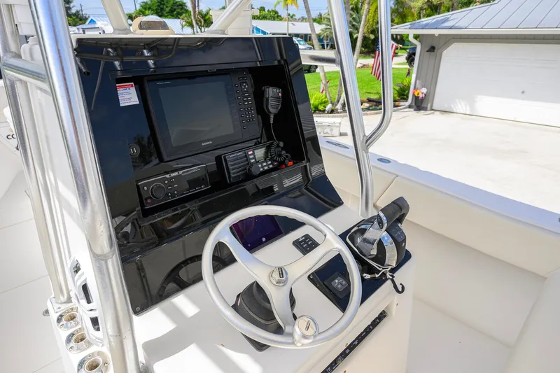 Slide: The Image of Steering console of a 2007 Competition 25 boat with navigation equipment and controls. - 22