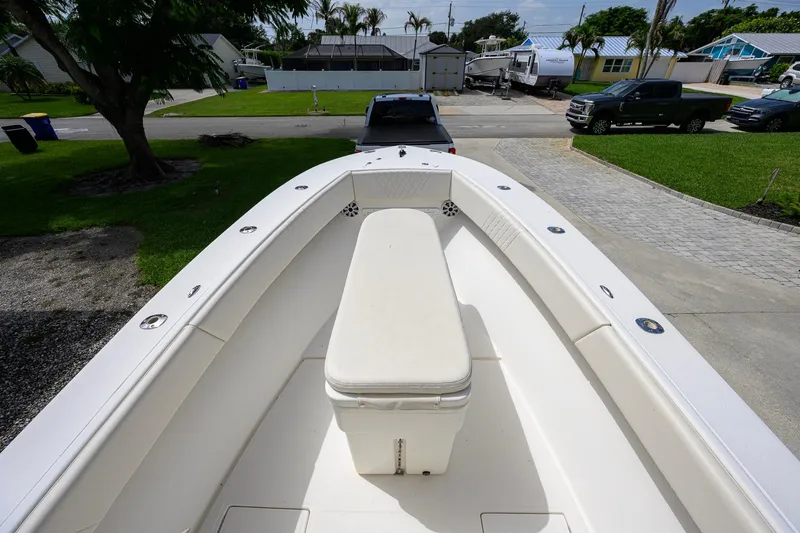 Slide: The Image of 2007 Competition 25 boat with spacious deck and seating, parked in a residential driveway. - 16