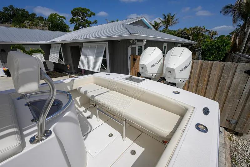Slide: The Image of 2007 Competition 25 boat with dual Mercury engines, parked near a house with shutters. - 29