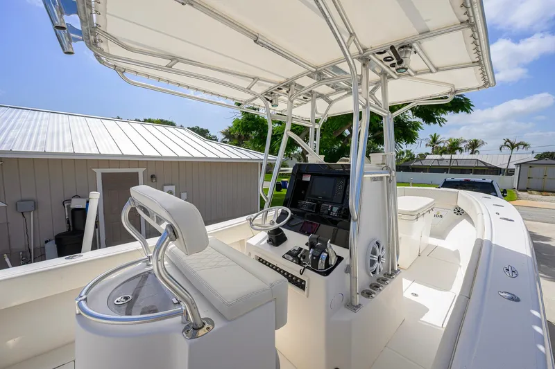 Slide: The Image of 2007 Competition 25 boat interior with helm, seating, and navigation equipment under canopy. - 19