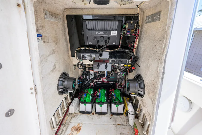 Slide: The Image of Electrical system inside a 2007 Competition 25 boat, featuring Garmin equipment and multiple batteries. - 33