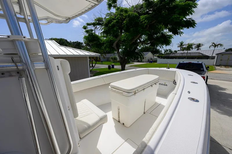 Slide: The Image of 2007 Competition 25 boat with seating and storage, parked outdoors under a clear sky. - 18