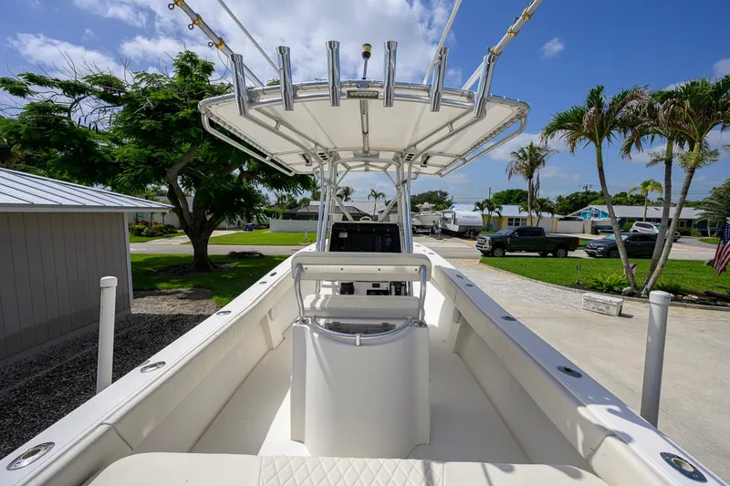 Slide: The Image of 2007 Competition 25 boat with T-top, parked in a sunny residential area. - 23
