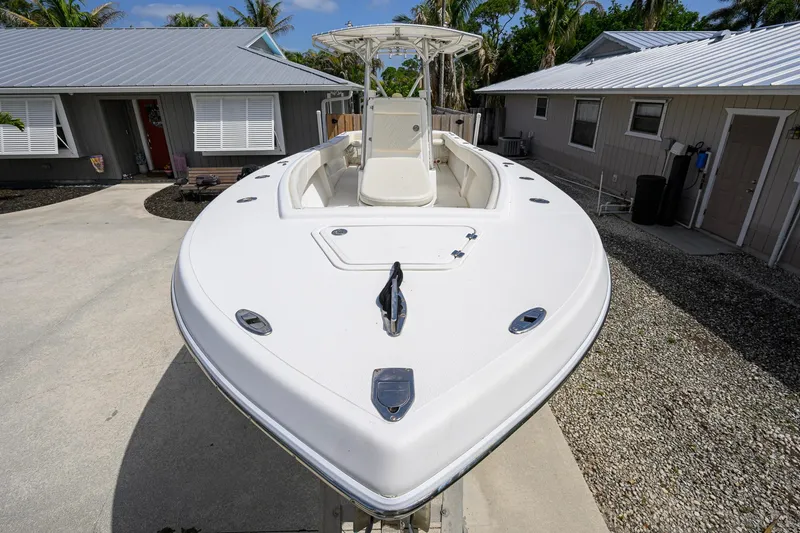 Slide: The Image of 2007 Competition 25 boat parked in driveway, surrounded by houses and palm trees. - 15