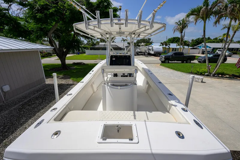 Slide: The Image of 2007 Competition 25 boat with center console, docked in a sunny residential area. - 3