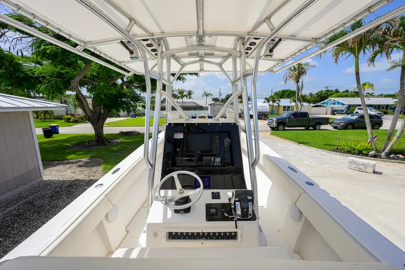 Slide: The Image of 2007 Competition 25 boat cockpit with steering wheel and control panel, parked outdoors. - 2