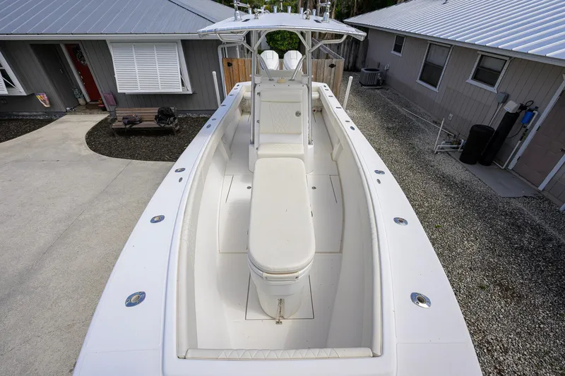 Slide: The Image of 2007 Competition 25 boat parked in driveway, showcasing spacious deck and seating. - 1
