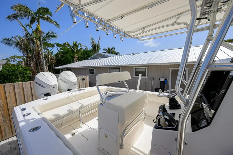 Slide: The Image of 2007 Competition 25 boat with dual Mercury engines, docked near tropical foliage and a house. - 27