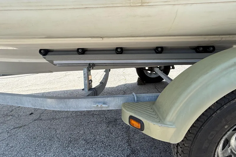 Slide: The Image of Trailer supporting a 2014 Marlago 520CC boat, showcasing undercarriage and wheel detail. - 16