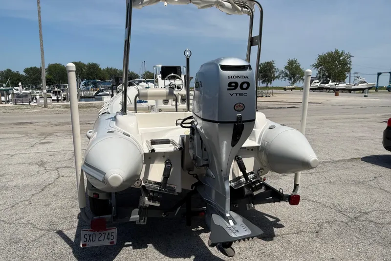 Slide: The Image of 2014 Marlago 520CC boat with Honda 90 VTEC engine at a marina. - 4