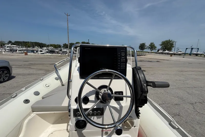 Slide: The Image of 2014 Marlago 520CC boat dashboard with steering wheel and navigation system at marina. - 7