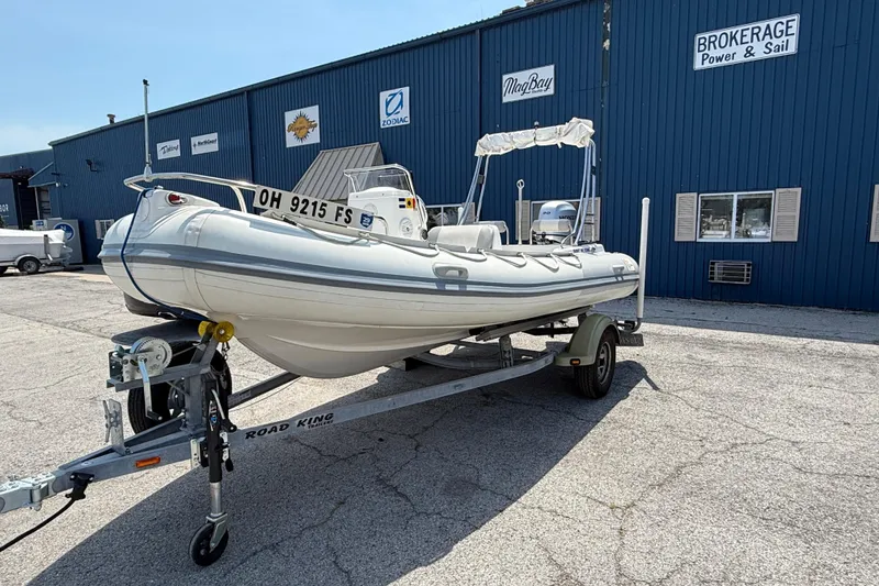 Slide: The Image of 2014 Marlago 520CC boat on trailer outside brokerage building. - 3