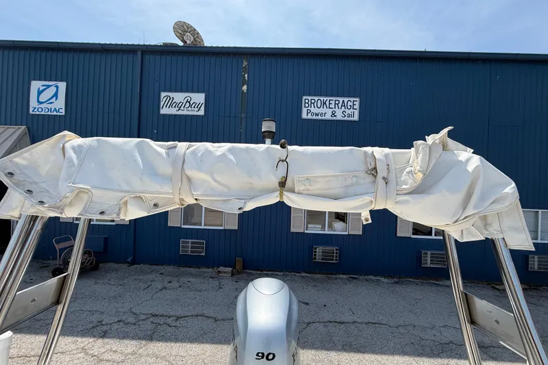 Slide: The Image of 2014 Marlago 520CC boat with covered canopy, parked near brokerage building. - 13