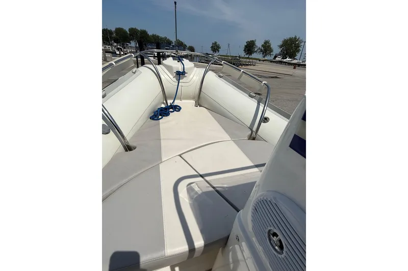 Slide: The Image of 2014 Marlago 520CC boat interior with white seating and blue rope on deck. - 8