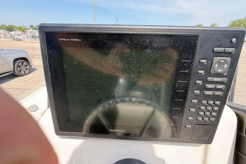 Slide: The Image of Garmin GPSMAP 1040xs on 2014 Marlago 520CC boat, parked near vehicles. - 12