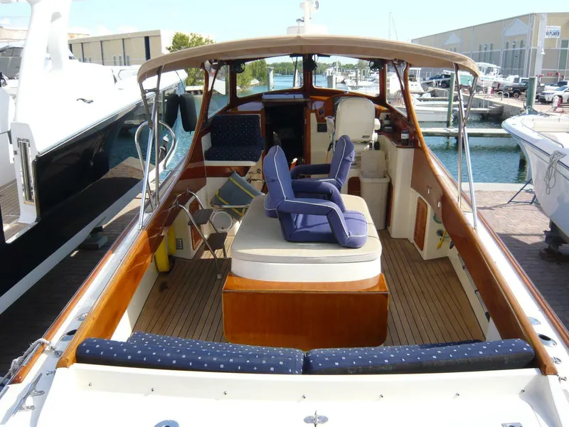 Slide: The Image of Hinckley 36 Classic 1998 yacht interior with seating and wooden deck at marina. - 9