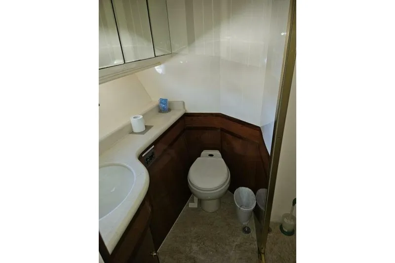 Slide: The Image of Compact bathroom in a 2003 Johnson FLY model, featuring a toilet and sink. - 25
