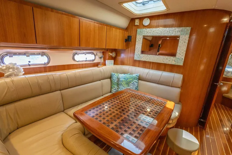 Slide: The Image of Luxurious interior of 2000 Tiara Yachts 5200 Express with elegant wood finish and plush seating. - 13