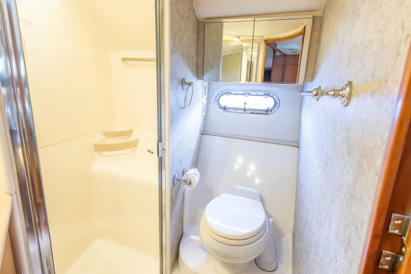 Slide: The Image of Bathroom interior of 2000 Tiara Yachts 5200 Express, featuring shower and toilet. - 17